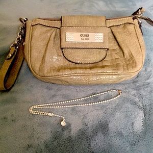 Guess  Wristlet Clutch Purse it’s rhinestones.